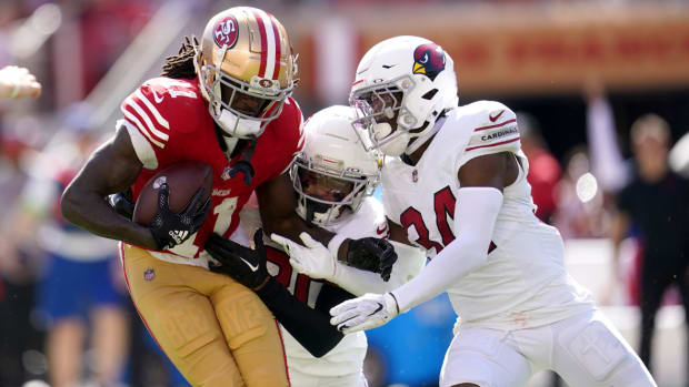 San Francisco 49ers wide receiver Brandon Aiyuk (11) holds onto the ball after making a catch next to Arizona Cardinals cornerback Marco Wilson (20) and safety Jalen Thompson (34) in the second quarter at Levi's Stadium.